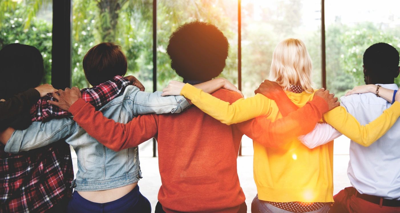 Friends with arms around each other